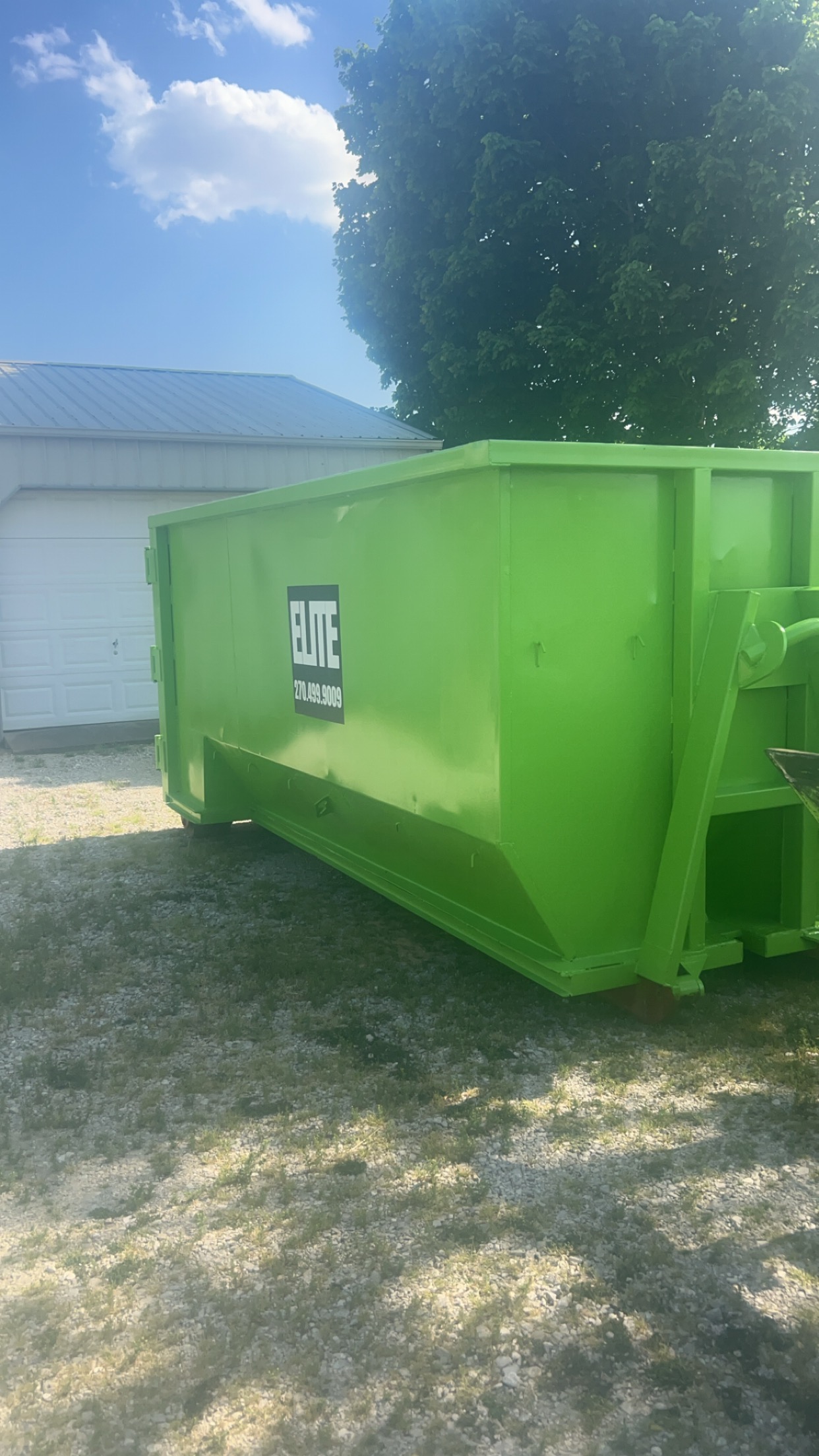 Commercial dumpster behind an office in Kentucky, ready for pickup by Elite Waste Services